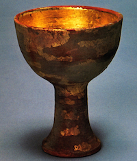 Image of an old, worn chalice, in the style of the holy grail.